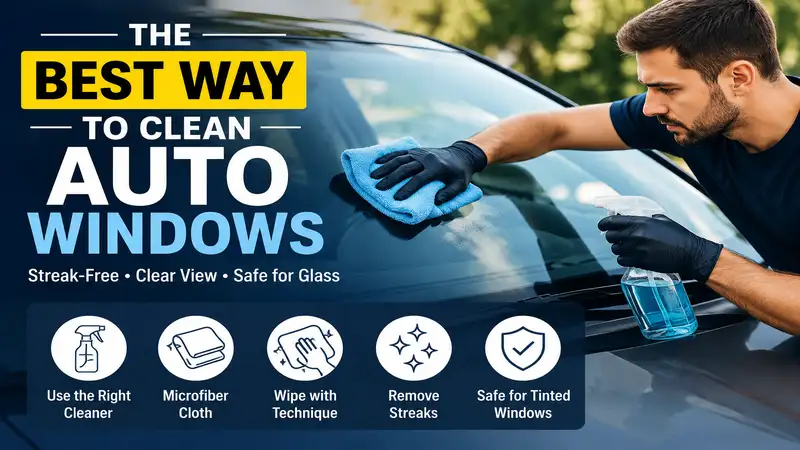 Driver cleaning a car windshield with a microfiber cloth demonstrating the best way to clean auto windows for a streak-free finish