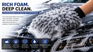 Microfiber car wash mitt covered in rich foam during a hand car washing process.