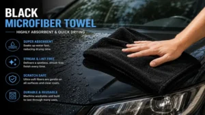 Highly absorbent black microfiber towel drying a freshly washed vehicle